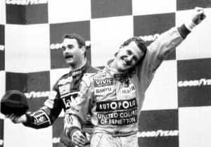 ** FILE ** German F1 racing driver Michael Schumacher jcelebrates to cheering crowd during the podium ceremony for the Belgian F1 Grand Prix in Spa Francorchams in this Aug. 30, 1992 file photo. In background is the new F1 champion Nigel Mansell from Great Britain. In the season final on Sunday, Oct. 22, 2006 in Sao Paulo Schumacher will start to what he says is the final race of his career. Seven-time World Champion Schumacher has a 10-point disadvantage to his rival Fernando Alonso. (AP Photo/Roberto Pfeil)