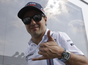 Williams driver Felipe Massa of Brazil cheers as he walks in the paddock at the Monza racetrack, in Monza, Italy , Thursday, Sept. 1, 2016. With a dedication to mentor Michael Schumacher, Williams driver Felipe Massa announced Thursday that he will retire from Formula One at the end of the season. (AP Photo/Luca Bruno)