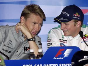 Finnish F1 drivers Mika Hakkinen, left, and Kimi Raikkonen share a laugh during a news conference at the Indianapolis Motor Speedway on Thursday, Sept. 27, 2001. Hikkonen will leave the Sauber team in 2002 and replace Hakkinen on the McClaren team. (AP Photo/Darron Cummings)