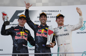 Red Bull driver Daniel Ricciardo, centre, of Australia celebrates on the podium with second placed teammate Max Verstappen, left, of the Netherlands and third placed Mercedes driver Nico Rosberg of Germany after winning the Malaysian Formula One Grand Prix at the Sepang International Circuit in Sepang, Malaysia, Sunday, Oct. 2, 2016. (AP Photo/Vincent Thian)