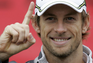 Jenson Button, the new Formula One motor racing World Champion, indicates that he is number one, while attending his first public appearance since winning the championship in Brazil, at Bluewater shopping centre in Kent, England Tuesday, Oct. 20, 2009. (AP Photo/Kirsty Wigglesworth)