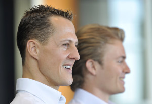 Mercedes Grand Prix driver Michael Schumacher of Germany, left, and teammate Nico Rosberg of Germany, right, pose for photographers before giving a news conference held at a Mercedes showroom in Manama, Bahrain, Thursday, March 11, 2010. The Bahrain Formula One Grand Prix will take place here on Sunday. (AP Photo/Gero Breloer)