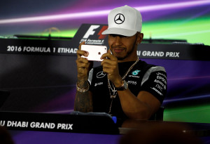 Formula One - F1 - Abu Dhabi Grand Prix - Yas Marina Circuit, Abu Dhabi, United Arab Emirates - 24/11/2016 - Mercedes' Formula One driver, Lewis Hamilton of Britain films journalists and photographers with his smart phone during a news conference. REUTERS/Hamad I Mohammed