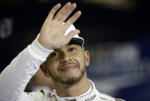 Mercedes driver Lewis Hamilton of Britain waves after he clocked the fastest time during the qualifying session at the Yas Marina racetrack in Abu Dhabi, United Arab Emirates, Saturday, Nov. 26, 2016. The Emirates Formula One Grand Prix will take place on Sunday. (AP Photo/Luca Bruno)
