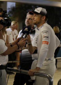 McLaren driver Jenson Button of Britain talks to a tv crew after he had to abandon the Emirates Formula One Grand Prix at the Yas Marina racetrack in Abu Dhabi, United Arab Emirates, Sunday, Nov. 27, 2016. (AP Photo/Luca Bruno)