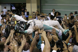 Mercedes driver Nico Rosberg of Germany is carried aloft by his team mechanics after winning the 2016 world championship during the Emirates Formula One Grand Prix at the Yas Marina racetrack in Abu Dhabi, United Arab Emirates, Sunday, Nov. 27, 2016. (AP Photo/Luca Bruno)