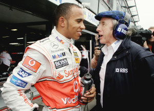 Formula One rookie Lewis Hamilton left, of Britain talks with former champion Jackie Stewart outside his McLaren Mercedes team garage during the first practice session for the Australian Grand Prix in Melbourne, Australia, Friday, March 16, 2007. Sunday's race kicks off the 2007 Formula One season. (AP Photo/Oliver Multhaup)