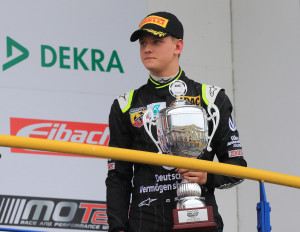 German Formula 4 driver Mick Schumacher of Van Amersfoort holds his best rookie award during the season kickoff in Oschersleben, Germany, Saturday, April 25, 2015, after ranking 9th in the race. He is the son of former Formula One World Champion Michael Schumacher. (Jens Wolf/dpa via AP)