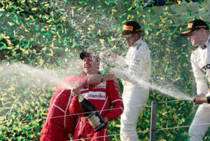 Formula One - F1 - Australian Grand Prix - Melbourne, Australia - 26/03/2017 - Ferrari driver Sebastian Vettel of Germany (2nd L) sprays champagne alongside second-placed Mercedes driver Lewis Hamilton (2nd R) of Britain and team mate Valtteri Bottas of Finland (R) on the podium. REUTERS/Jason Reed