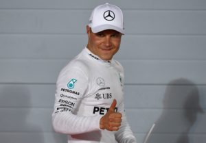 Mercedes' Finnish driver Valtteri Bottas celebrates after taking the pole position at the end of the qualifying for the Bahrain Formula One Grand Prix at the Sakhir circuit in Manama on April 15, 2017. Bottas claimed a first career pole position when he edged out Mercedes team-mate Lewis Hamilton in qualifying at the Bahrain Grand Prix. Ferrari's Sebastian Vettel, who won the season-opener in Australia, was third fastest. / AFP PHOTO / Andrej ISAKOVIC