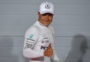 Mercedes' Finnish driver Valtteri Bottas celebrates after taking the pole position at the end of the qualifying for the Bahrain Formula One Grand Prix at the Sakhir circuit in Manama on April 15, 2017.  Bottas claimed a first career pole position when he edged out Mercedes team-mate Lewis Hamilton in qualifying at the Bahrain Grand Prix. Ferrari's Sebastian Vettel, who won the season-opener in Australia, was third fastest.  / AFP PHOTO / Andrej ISAKOVIC