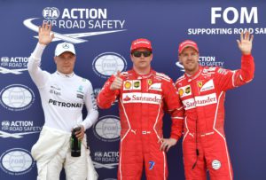 Ferrari's Finnish driver Kimi Raikkonen (C) celebrates after winning the pole position next to second placed Ferrari's German driver Sebastian Vettel (R) and third placed Mercedes' Finnish driver Valtteri Bottas after the qualifying session at the Monaco street circuit, on May 27, 2017 in Monaco, a day ahead of the Monaco Formula 1 Grand Prix. / AFP PHOTO / Andrej ISAKOVIC