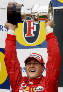German Ferrari driver Michael Schumacher celebrates during the victory ceremony of the Belgian Formula One Grand Prix at the Spa-Francorchamps circuit, Sunday, Aug. 29, 2004, after finishing second place. McLaren driver Kimi Raikkonen won the race. Michael Schumacher clinched an unprecedented seventh Formula One drivers' title at the Belgian Grand Prix on Sunday. (AP Photo/Bas Czerwinski)