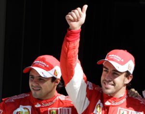 Ferrari driver Fernando Alonso of Spain gives the thumb-up sign after setting the pole position for the Italian Formula One Grand Prix, flanked by his Brazilian teammate Felipe Massa, who set the third fastest time, at the Monza racetrack, in Monza, Italy, Saturday, Sept. 11, 2010. Alonso marked his Ferrari debut at the Italian Grand Prix by taking pole position for the Formula One race. The two-time world champion from Spain set the pace with a lap of 1 minute, 21.962 seconds Saturday for his 19th career pole. It is the Italian team's first pole since the 2008 Brazilian GP, a span of 30 races. (AP Photo/Luca Bruno)
