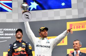 Winner Mercedes' British driver Lewis Hamilton (C) celebrates on the podium after the Belgian Formula One Grand Prix at the Spa-Francorchamps circuit in Spa on August 27, 2017. / AFP PHOTO / LOIC VENANCE