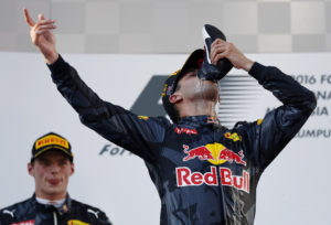 Red Bull driver Daniel Ricciardo of Australia drinks champagne from his shoe as he celebrates on the podium after winning the Malaysian Formula One Grand Prix at the Sepang International Circuit in Sepang, Malaysia, Sunday, Oct. 2, 2016. (AP Photo/Vincent Thian)