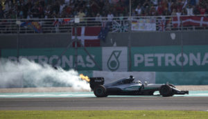 Flames and smoke pour from the rear of Mercedes driver Lewis Hamilton of Britain's car during the Malaysian Formula One Grand Prix at the Sepang International Circuit in Sepang, Malaysia, Sunday, Oct. 2, 2016. (AP Photo/Brian Ching)