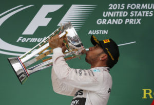 Mercedes driver Lewis Hamilton, of Britain, kisses his trophy after winning the world championship win his victory at the Formula One U.S. Grand Prix auto race at the Circuit of the Americas, Sunday, Oct. 25, 2015, in Austin, Texas.(AP Photo/John Locher)