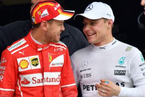 Mercedes' Finnish driver Valtteri Bottas (R) and Ferrari's German driver Sebastian Vettel chat after taking the first and second place for the start of the Brazilian Formula One Grand Prix respectively, in the Q3 qualifying session at the Interlagos circuit in Sao Paulo, Brazil, on November 11, 2017. / AFP PHOTO / Nelson ALMEIDA