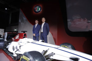 Drivers Marcus Ericsson, of Sweden, right, and Charles Leclerc, of Monaco, pose for photographers near the newly unveiled Alfa Romeo Sauber F1 Team on the occasion of its official presentation in Arese, Italy, Saturday, Dec. 2, 2017. The Alfa Romeo Sauber F1 Team will compete in the 2018 Formula 1 World Championship. (AP Photo/Luca Bruno)