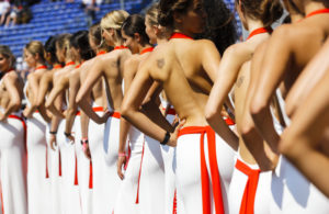 FILE - In this file photo dated Saturday, May 27, 2017, so called "grid girls" line up after the qualifying session for the Formula One Grand Prix at the Monaco racetrack in Monaco. Formula One says it is ending the practice of using "grid girls" and "podium girls" at races, with F1 managing director of commercial operations Sean Bratches saying Wednesday Jan. 31, 2018, the use of the women on the grid is clearly "at odds with modern day societal norms." (AP Photo/Frank Augstein, FILE)