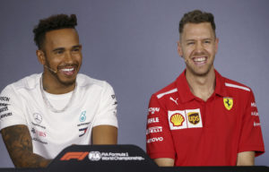 Mercedes driver Lewis Hamilton of Britain and Ferrari driver Sebastian Vettel of Germany, right, laugh during a drivers' press conference at the Australian Formula One Grand Prix in Melbourne, Thursday, March 22, 2018. The first race of the 2018 seasons is on Sunday. (AP Photo/Rick Rycroft)