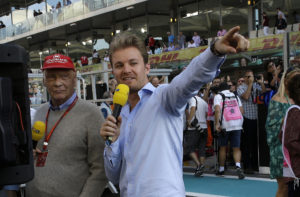 Formula One legend Niki Lauda, left, and last years' champion Nico Rosberg speak on TV ahead of the Emirates Formula One Grand Prix at the Yas Marina racetrack in Abu Dhabi, United Arab Emirates, Sunday, Nov. 26, 2017. (AP Photo/Luca Bruno)