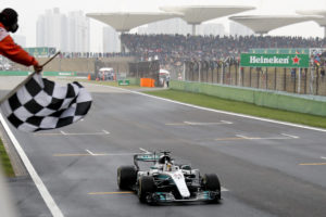 FILE - In this April 9, 2017, file photo, Mercedes driver Lewis Hamilton of Britain gets the checkered flag to win the Chinese Formula One Grand Prix at the Shanghai International Circuit in Shanghai, China. Formula One races in Bahrain and China will swap places early in the season as initially planned following approval of the 2018 F1 calendar on Wednesday, Dec. 6, 2017. (AP Photo/Andy Wong, Pool, File)