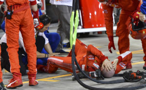 CORRECTS FROM BITTED TO HIT-Ferrari mechanic Francesco, lies on the ground after being hit by Ferrari driver Kimi Raikkonen during a pit stop the Bahrain Formula One Grand Prix, at the Formula One Bahrain International Circuit in Sakhir, Bahrain, Sunday, April 8, 2018. (Pool/Giuseppe Cacace Via AP)