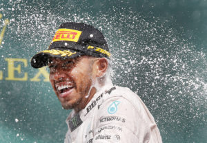 Britain's Mercedes driver Lewis Hamilton is sprayed with champagne after winning the German Formula One Grand Prix in Hockenheim, Germany, Sunday, July 31, 2016. (AP Photo/Michael Probst)
