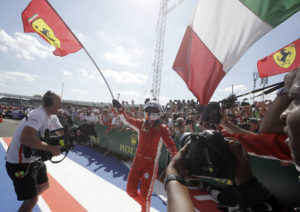 Ferrari driver Sebastian Vettel of Germany celebrates after winning the British Formula One Grand Prix at the Silverstone racetrack, Silverstone, England, Sunday, July 8, 2018. (AP Photo/Luca Bruno)