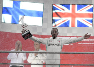Mercedes driver Lewis Hamilton of Britain celebrates on the podium after winning the German Formula One Grand Prix at the Hockenheimring racetrack in Hockenheim, Germany, Sunday, July 22, 2018. (AP Photo/Jens Meyer)