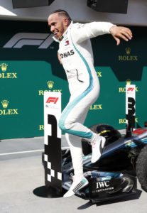 Mercedes driver Lewis Hamilton of Britain leaps from his car after winning the Hungarian Formula One Grand Prix, at the Hungaroring racetrack in Mogyorod, northeast of Budapest, Sunday, July 29, 2018. (AP Photo/Laszlo Balogh)