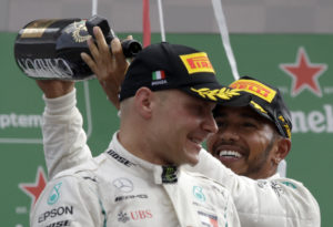 Mercedes driver Lewis Hamilton of Britain, right, celebrates with third placed Mercedes driver Valtteri Bottas of Finland after winning the Formula One Italy Grand Prix at the Monza racetrack, in Monza, Italy, Sunday, Sept. 2, 2018. (AP Photo/Luca Bruno)