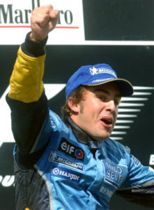 Spanish F1 driver Fernando Alonso of Renault clenches his fist as he celebrates on the podium after he won the Formula One Hungarian Grand Prix on the Hungaroring circuit, in Mogyorod, north-east of Budapest, Hungary, on Sunday, Aug. 24, 2003. (AP Photo/MTI, Imre Foeldi)