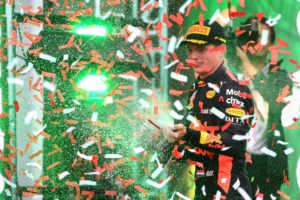 TOPSHOT - Red Bull's Dutch driver Max Verstappen celebrates on the podium after winning the F1 Mexico Grand Prix, at the Hermanos Rodriguez circuit in Mexico City on October 28, 2018. - Mercedes' British driver Lewis Hamilton became only the third Formula One driver in history to capture a fifth world title on Sunday as Max Verstappen won the Mexican Grand Prix. (Photo by ULISES RUIZ / AFP)