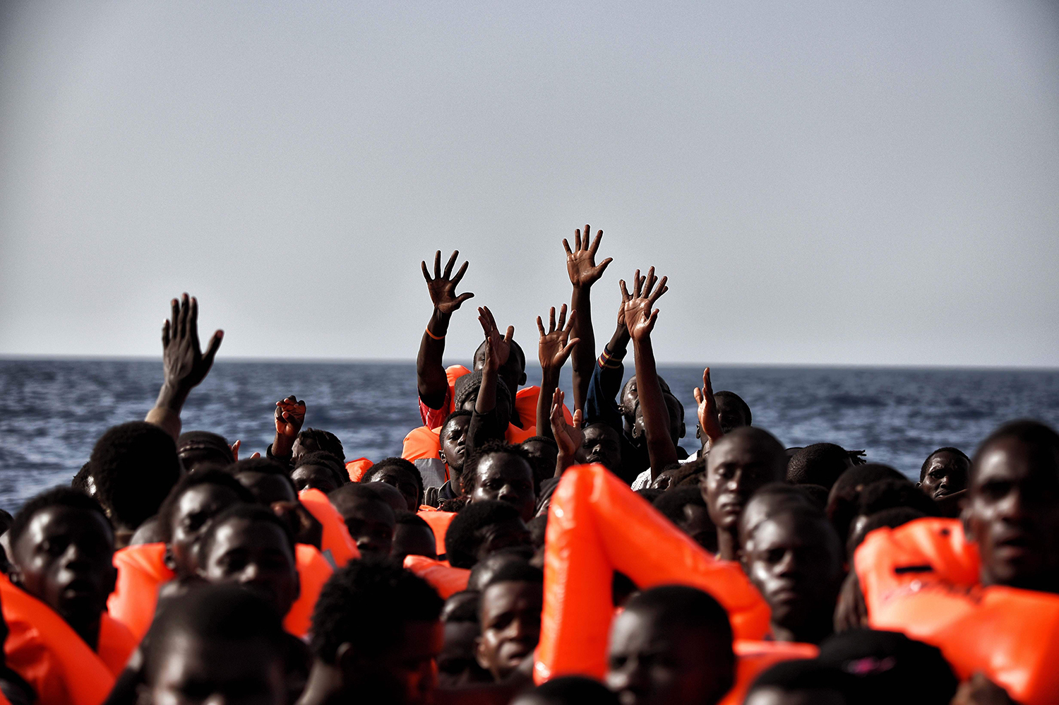 Migrants wait to be rescued in the mediteranean sea some 20 nautical miles north off the coast of Libya on October 3, 2016. / AFP PHOTO / ARIS MESSINIS / TT / kod 444