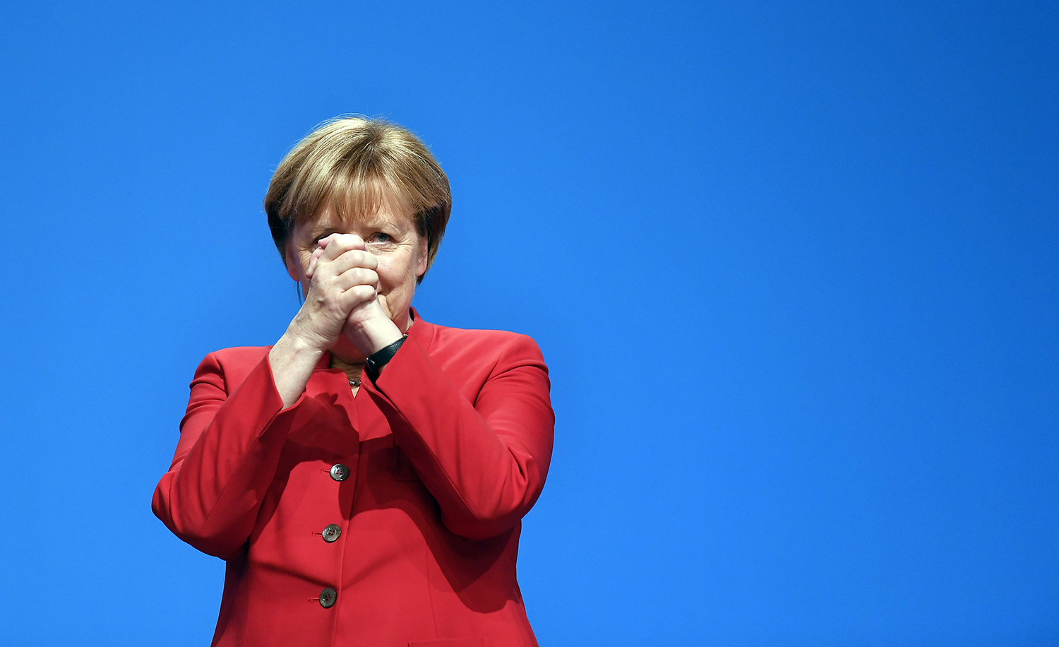 German Chancellor and Chairwomen of the CDU, Angela Merkel, gestures after her speech as part of a general party conference of the Christian Democratic Union (CDU) in Essen, Germany, Tuesday, Dec. 6, 2016. Merkel wants to secure the backing of her conservative party to head up the party's campaign for next September's election. (AP Photo/Martin Meissner)