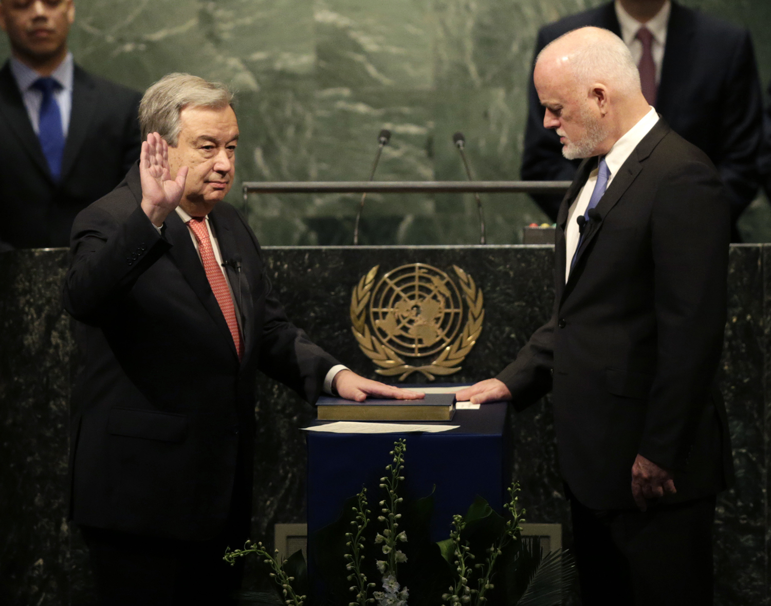 The United Nations Secretary-General designate Antonio Guterres, left, is sworn in by Peter Thomson, president of the UN General Assembly, at U.N. headquarters, Monday, Dec. 12, 2016. (AP Photo/Seth Wenig)