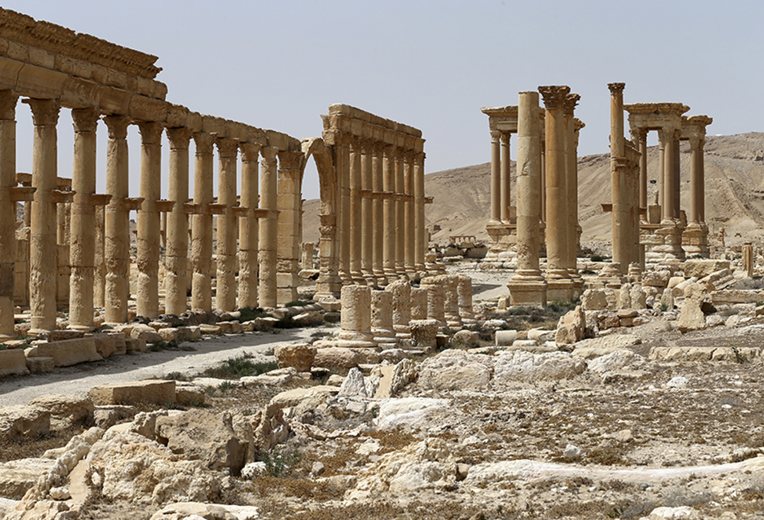 This file photo taken April 8, 2016 and provided by Russian Defense Ministry press service, shows the ancient ruins in Palmyra, Syria. Palmyra, the archaeological gem that Islamic State fighters retook Sunday, Dec. 11, 2016, from Syrian troops is a desert oasis surrounded by palm trees, and a UNESCO world heritage site, that boasts 2,000-year-old towering Roman-era colonnades and priceless artifacts. It is also a strategic crossroads linking the Syrian capital, Damascus, with the country's east and neighboring Iraq. (Russian Defense Ministry Press Service Photo via AP, File)