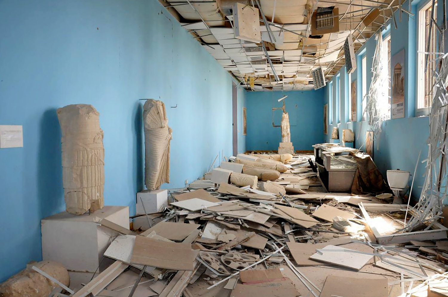 FILE - This file photo released March 27, 2016, by the Syrian official news agency SANA, shows destroyed statues at the damaged Palmyra Museum, in the city of Palmyra, central Syria. Palmyra, the archaeological gem that Islamic State fighters retook Sunday, Dec. 11, 2016, from Syrian troops, is a desert oasis surrounded by palm trees, and a UNESCO world heritage site, that boasts 2,000-year-old towering Roman-era colonnades and priceless artifacts. It is also a strategic crossroads linking the Syrian capital, Damascus, with the country's east and neighboring Iraq. (SANA via AP, file)