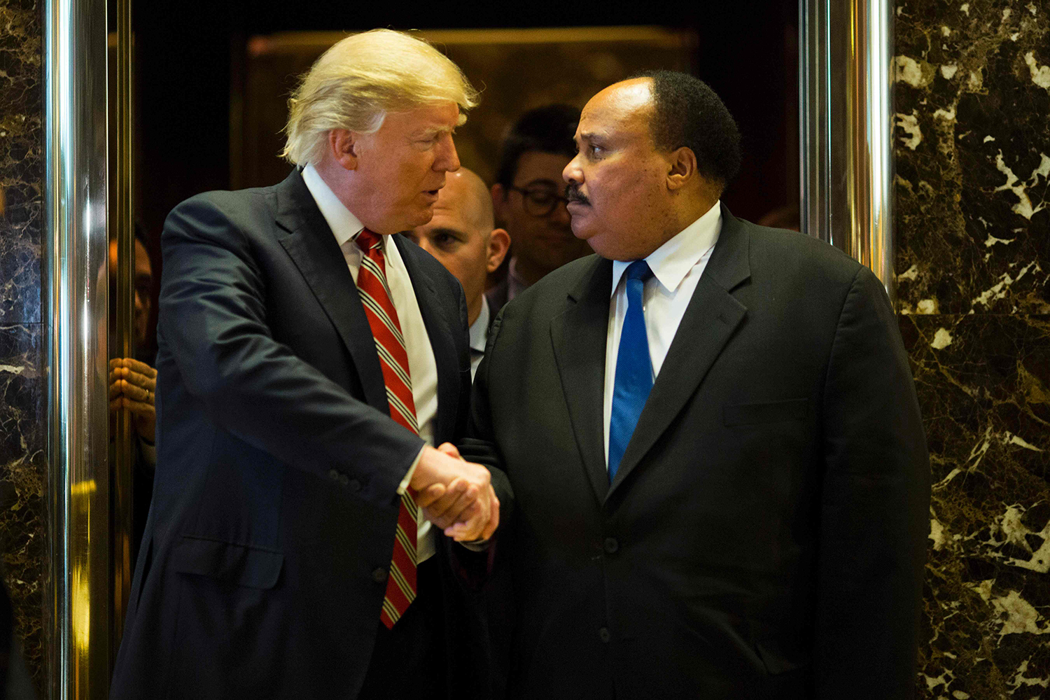 TOPSHOT - US President-elect Donald Trump shakes hands with Martin Luther King III after meeting at Trump Tower in New York City on January 16, 2017. The eldest son of American civil rights icon Martin Luther King Jr. met with US President-elect on the national holiday observed in remembrance of his late father. / AFP PHOTO / DOMINICK REUTER / TT / kod 444