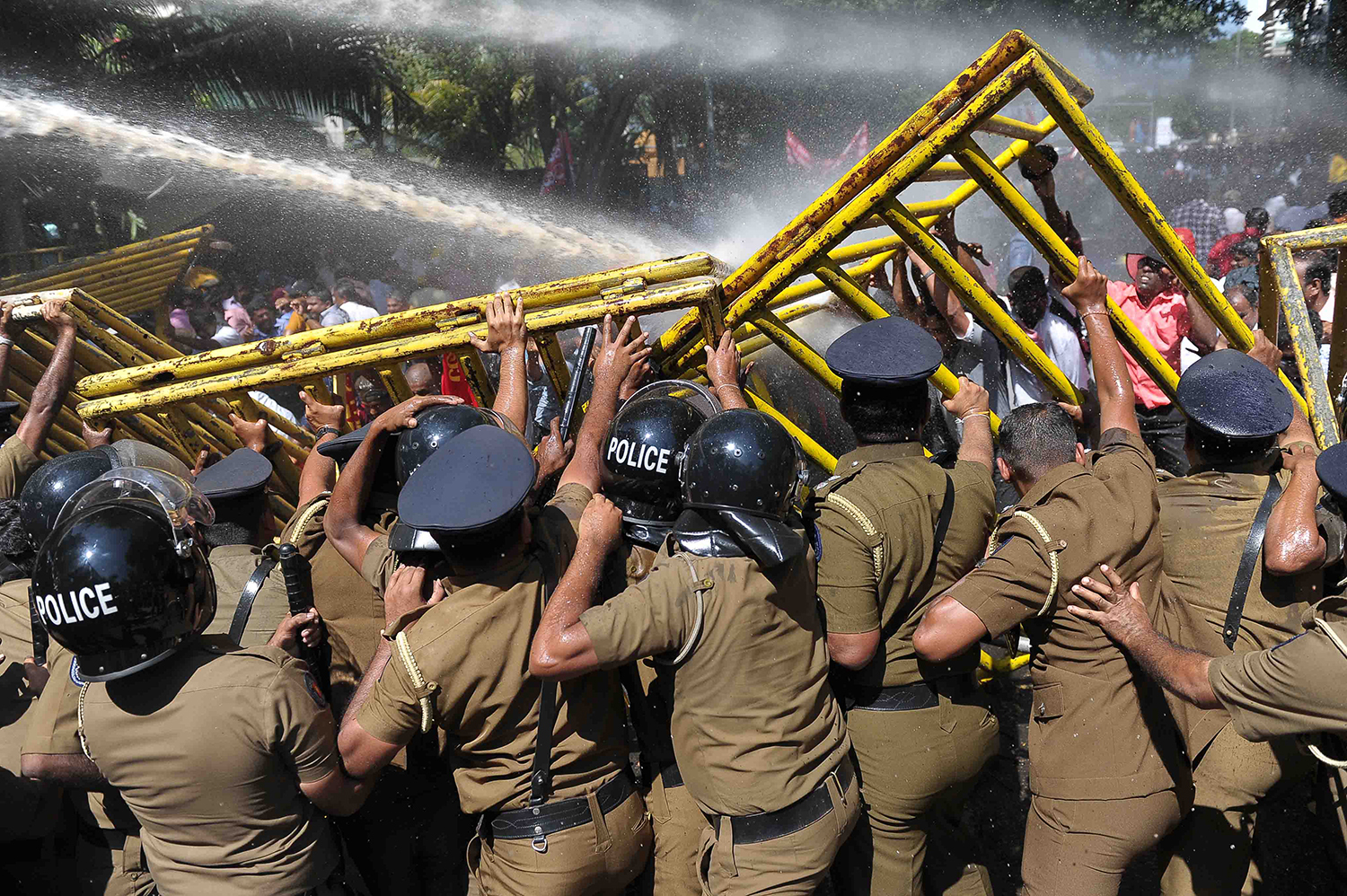 TOPSHOT - Sri Lankan police tryo to hold back demonstrators during a protest against the proposed sale of a stake in a loss-making port to a Chinese company in Colombo on February 1, 2017. Protesters led by the leftist People’s Liberation Front, are opposing plans to sell an 80 percent stake in the $1.4 billion deep sea port of Hambantota to China Merchants Port Holdings Company. / AFP PHOTO / Ishara S. KODIKARA / TT / kod 444
