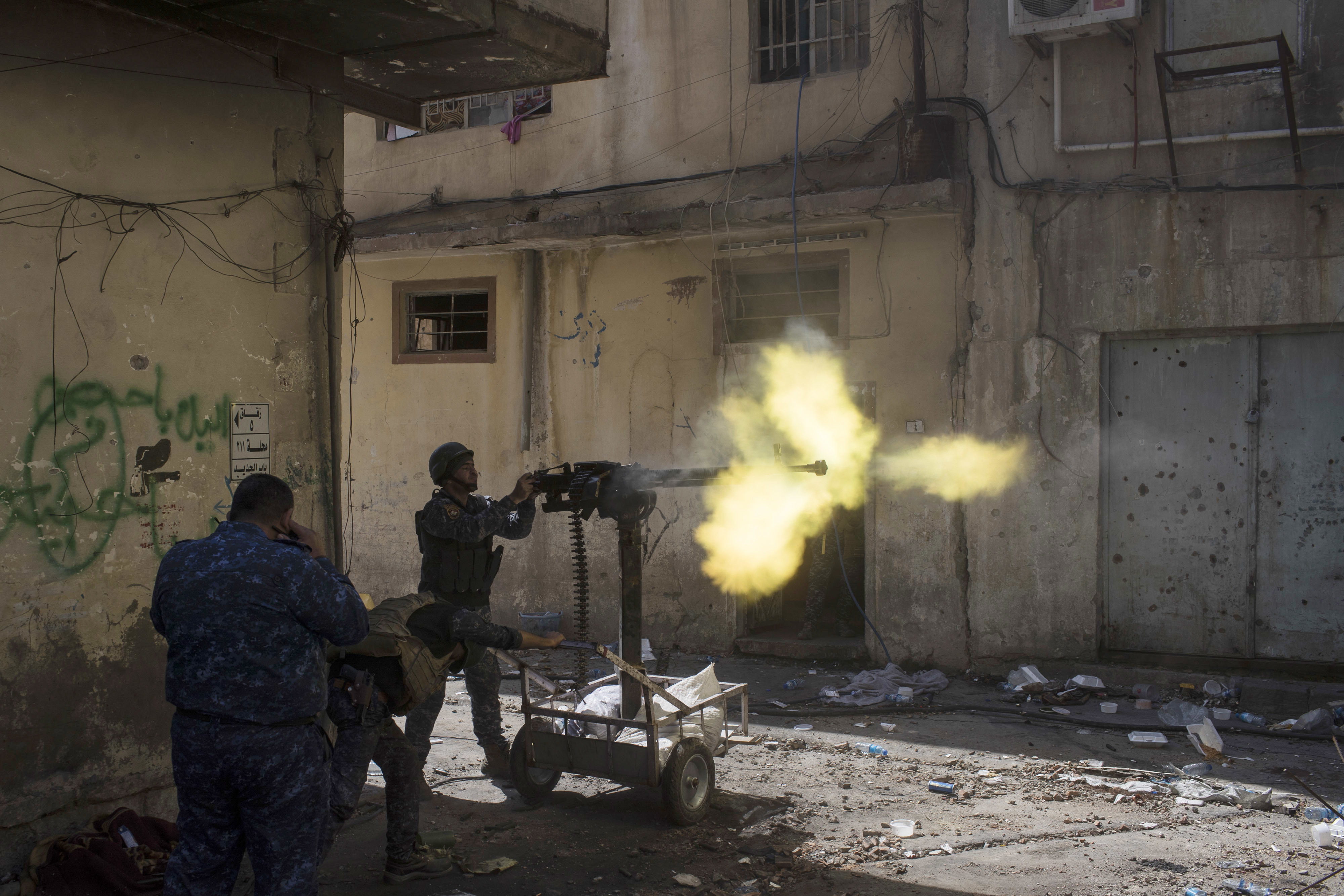 Federal policemen fire towards Islamic State positions in the old city during fighting on the western side of Mosul, Iraq, Thursday, March 30, 2017. (AP Photo/Felipe Dana)