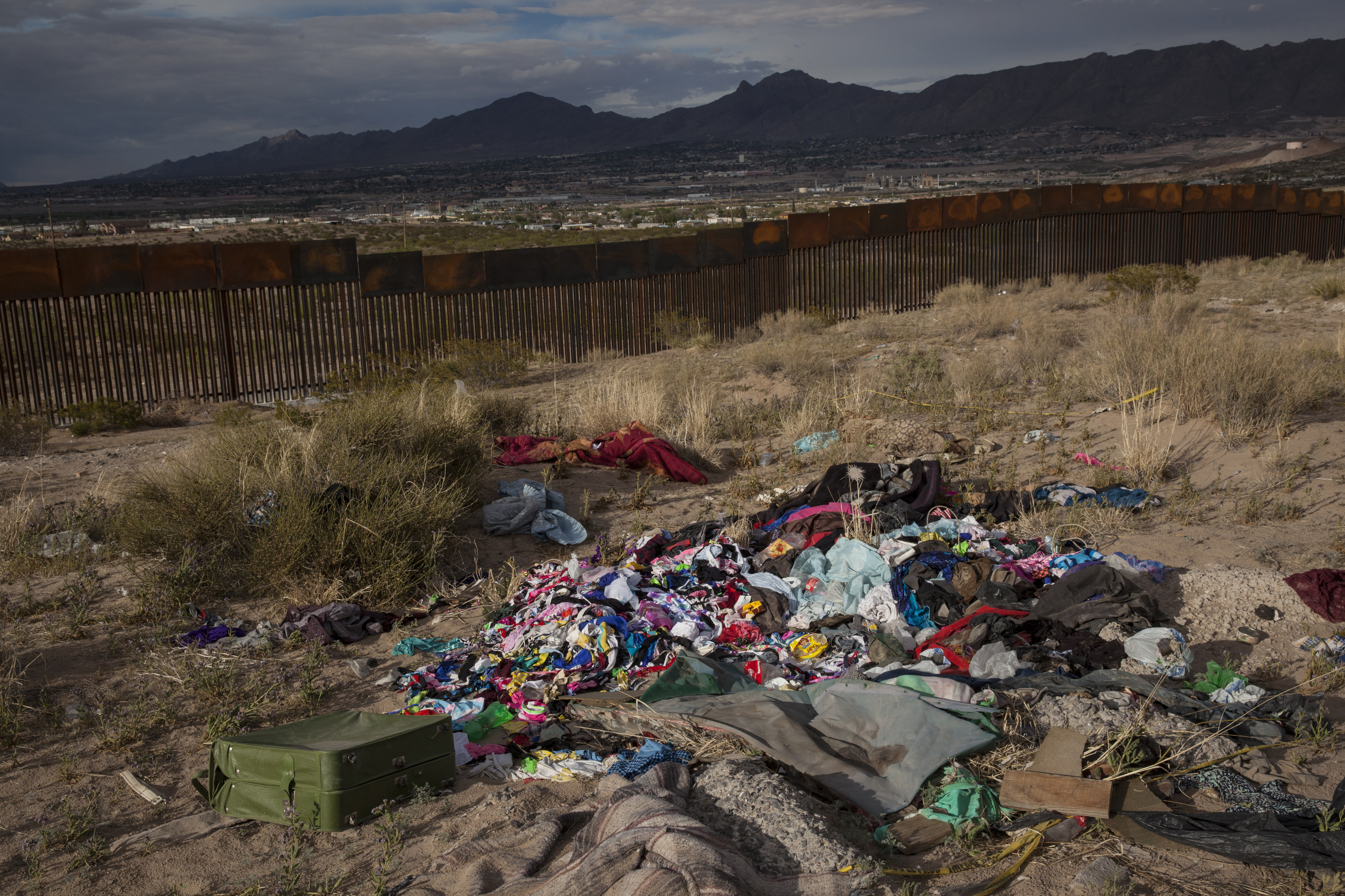 Clothes lay abandoned near a newly erected fence at the U.S.-Mexico border in the Anapra neighborhood of Ciudad Juarez, Mexico, Wednesday, March 29, 2017, across from Sunland Park, New Mexico. Residents of Anapra, a neighborhood anchored to the dunes, have fought to get running water, electricity and some paved streets in recent years. (AP Photo/Rodrigo Abd)