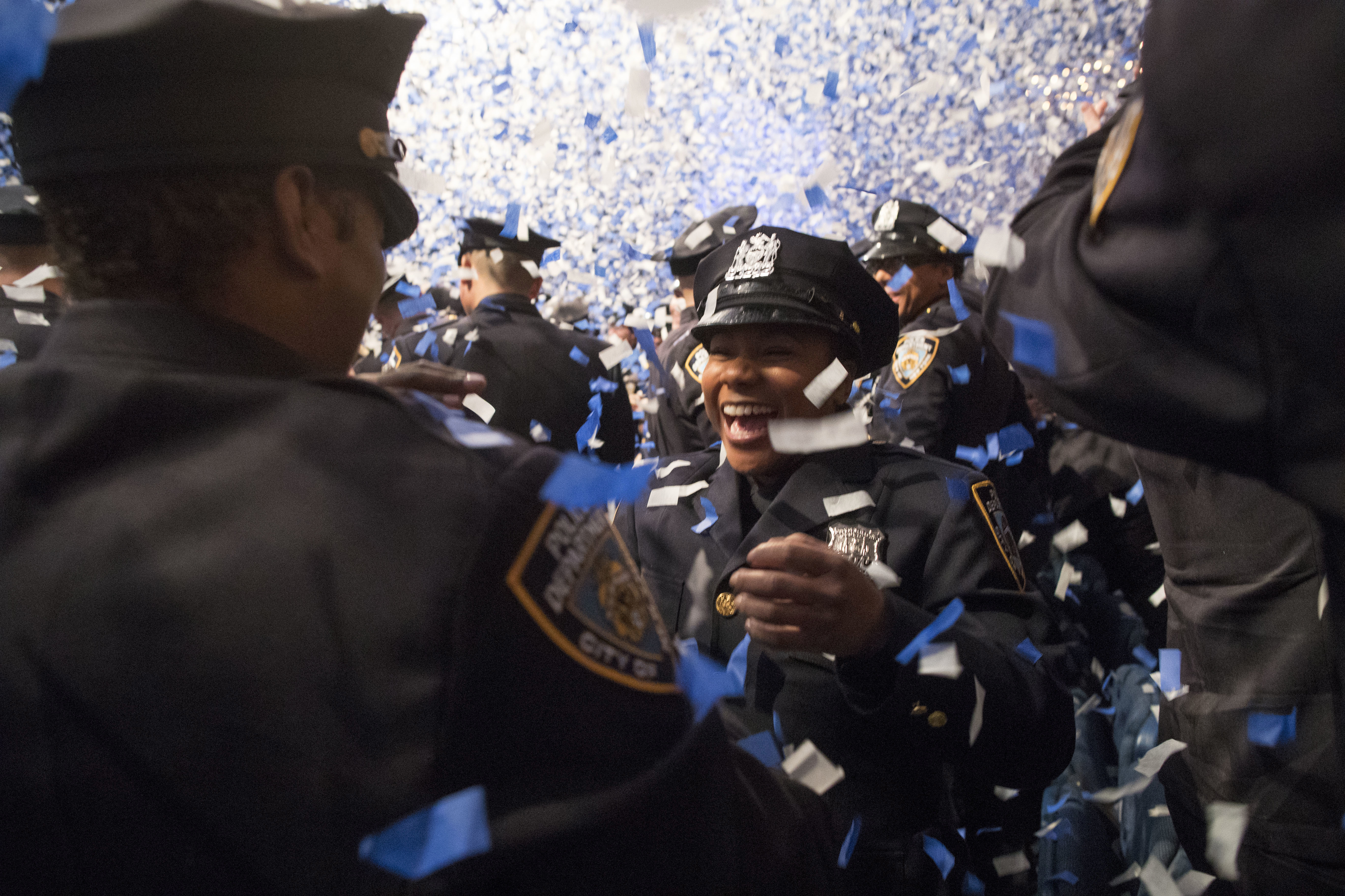 The newest members of the New York City police officers hug during their graduation ceremony, Thursday, March 30, 2017, in New York. Over 600 men and women took the oath of office and pledged to protect the people of New York City. (AP Photo/Mary Altaffer)