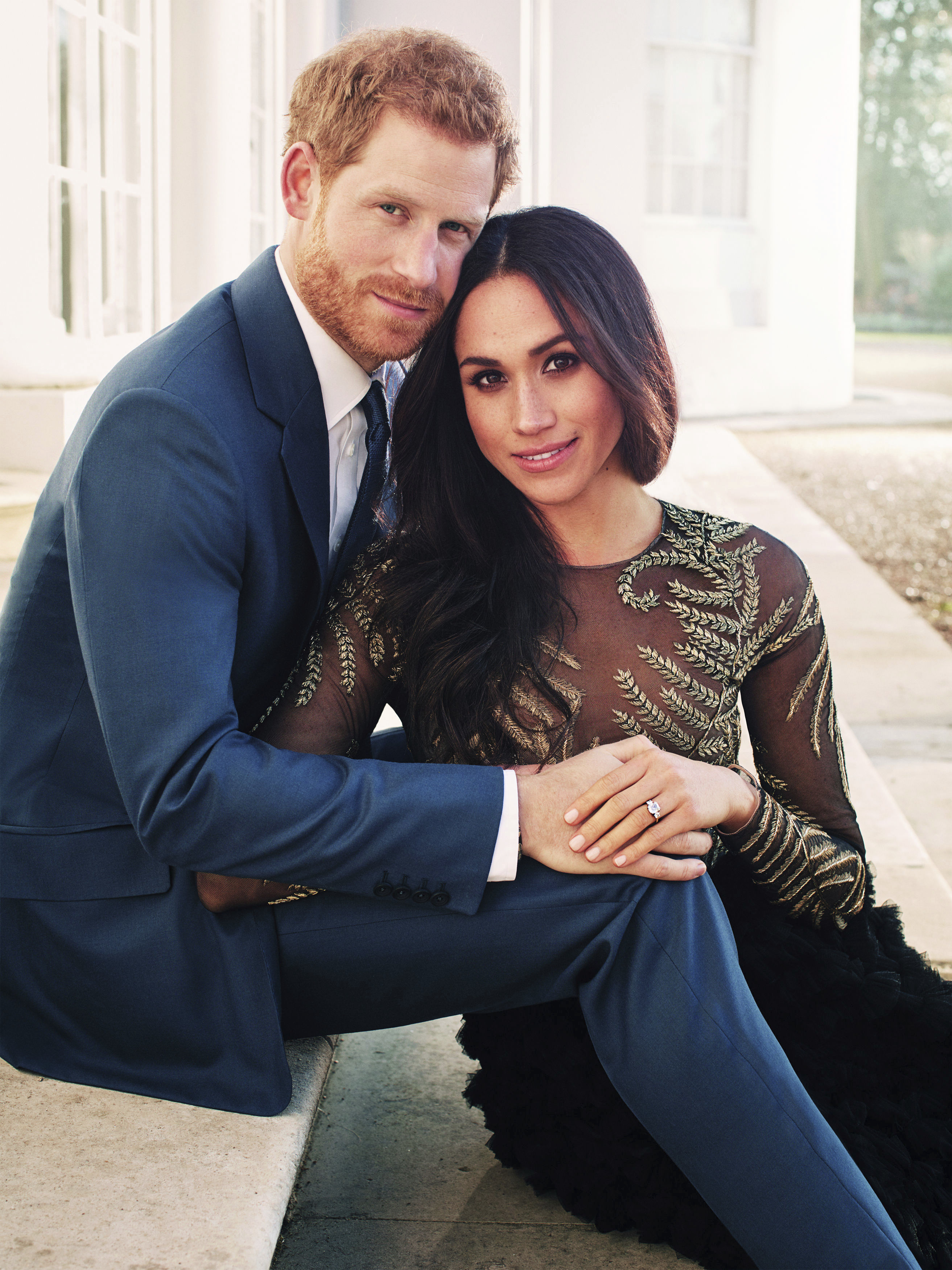 In this photo released by Kensington Palace on Thursday, Dec. 21, 2017, Britain's Prince Harry and Meghan Markle pose for one of two official engagement photos, at Frogmore House, in Windsor, England. (Alexi Lubomirski via AP)