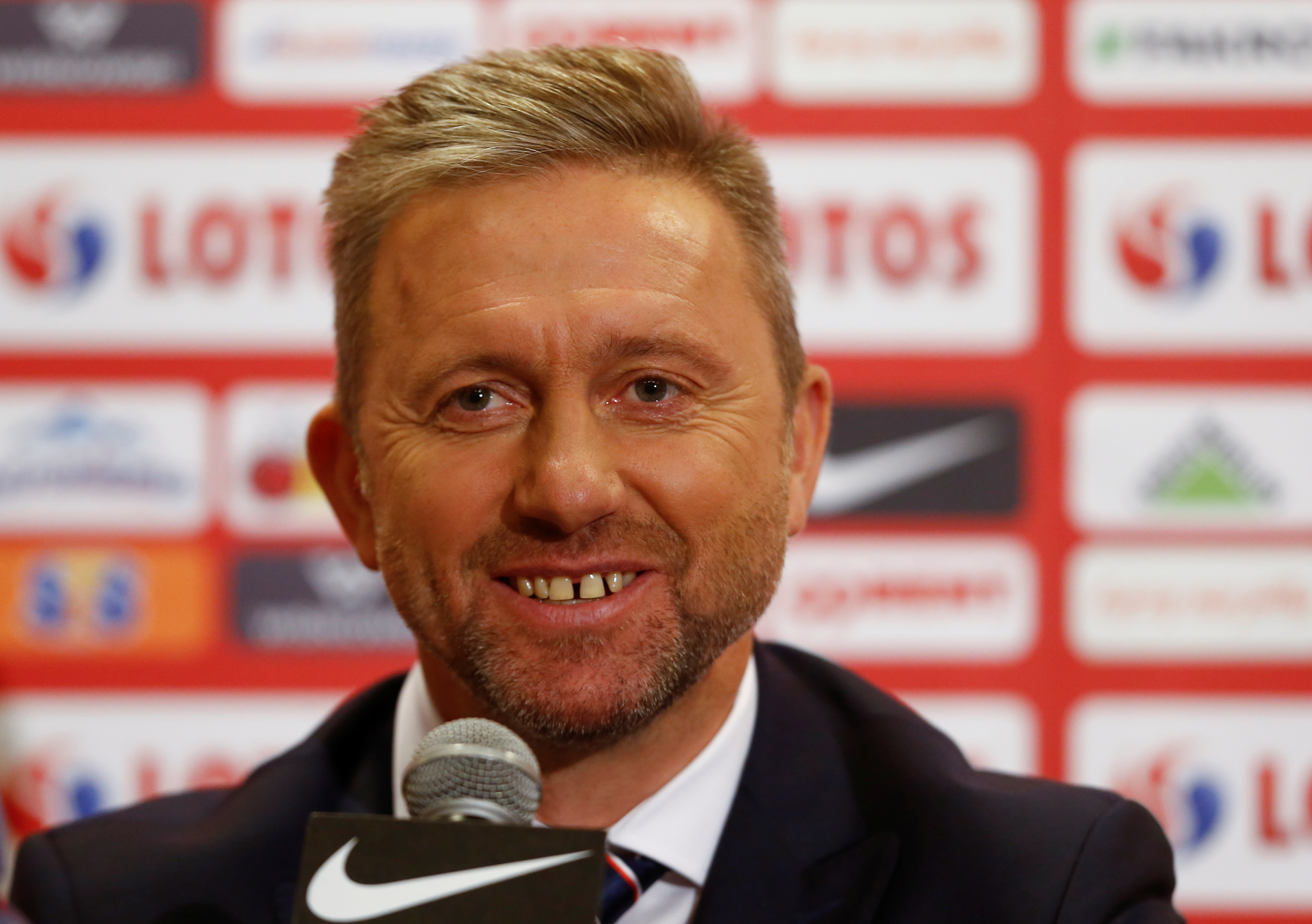 Jerzy Brzeczek, new coach for the Polish national soccer team smiles as he attends a news conference at National Stadium in Warsaw, Poland July 23, 2018. REUTERS/Kacper Pempel